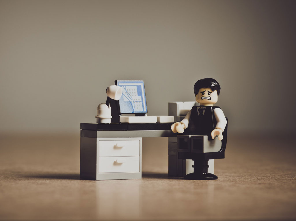 Stressed Lego man at desk