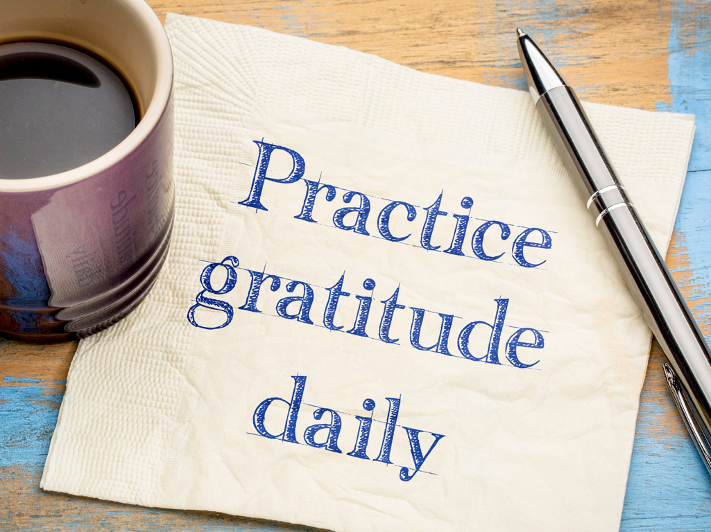 Napkin with writing saying “practice gratitude daily”