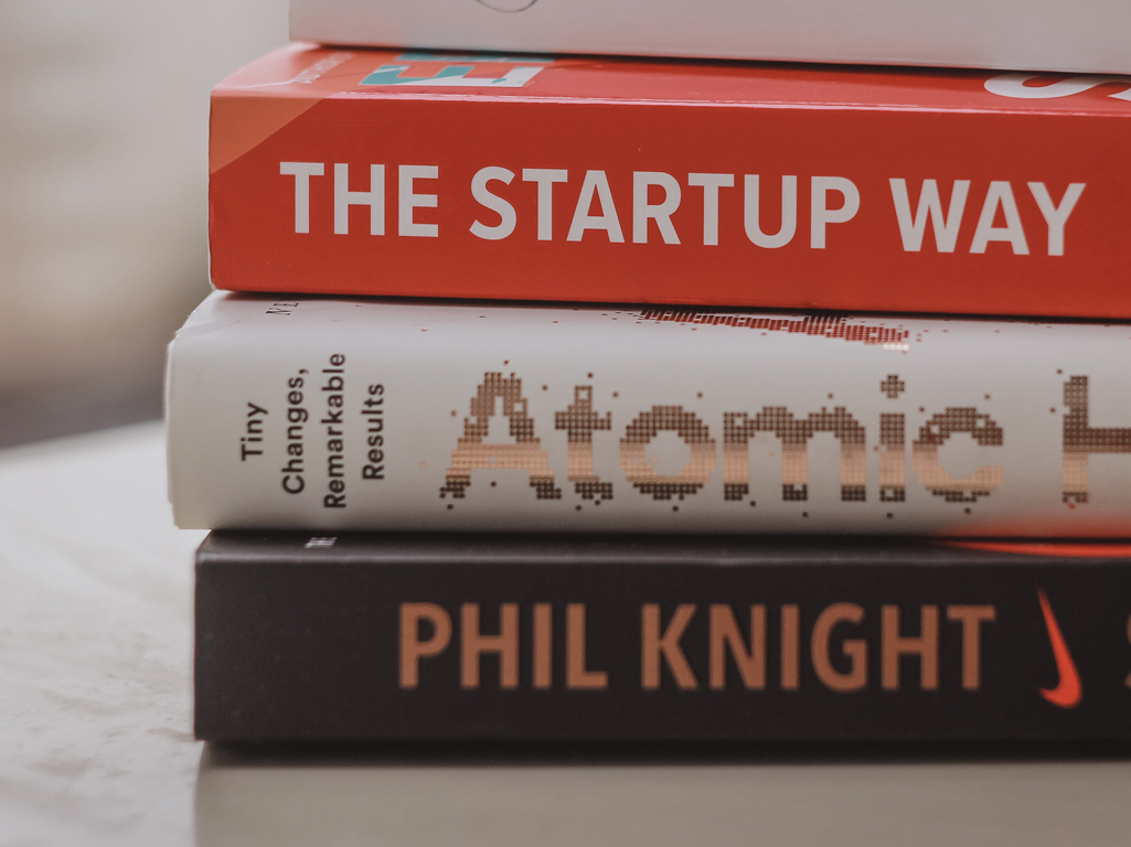 Pile of books including Shoe Dog by Phil Knight