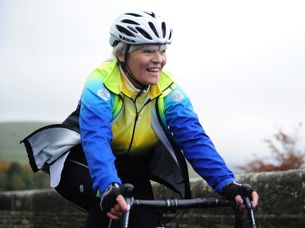 Woman bicycling and smiling