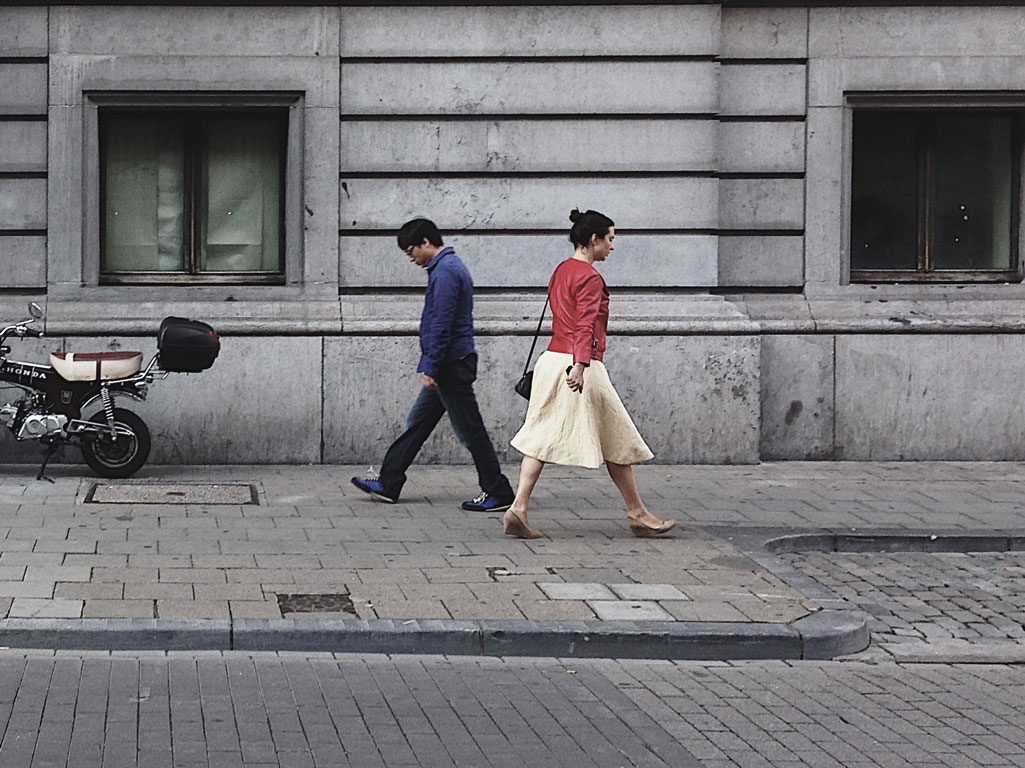 Man and woman walking in opposite directions