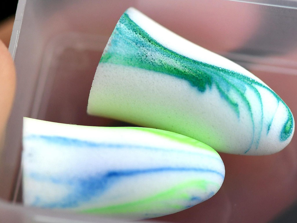 hand holding case with earplugs