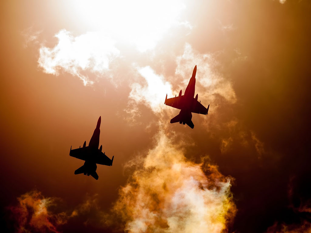 Two fighter jets flying together