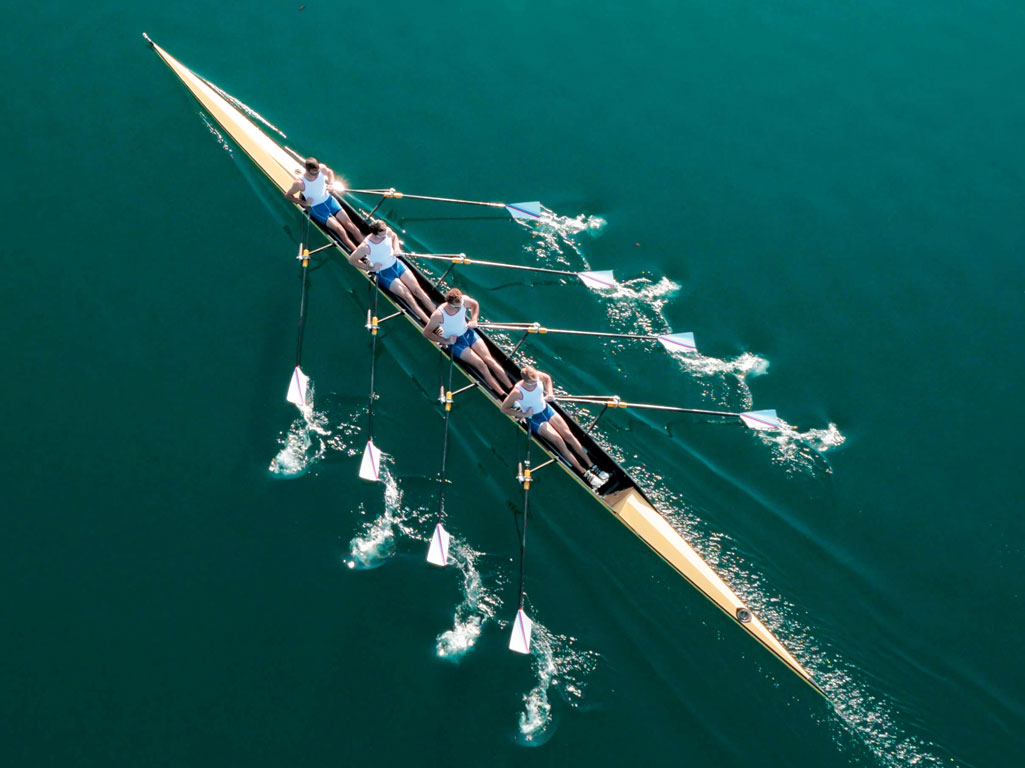 Crew team rowing in unison