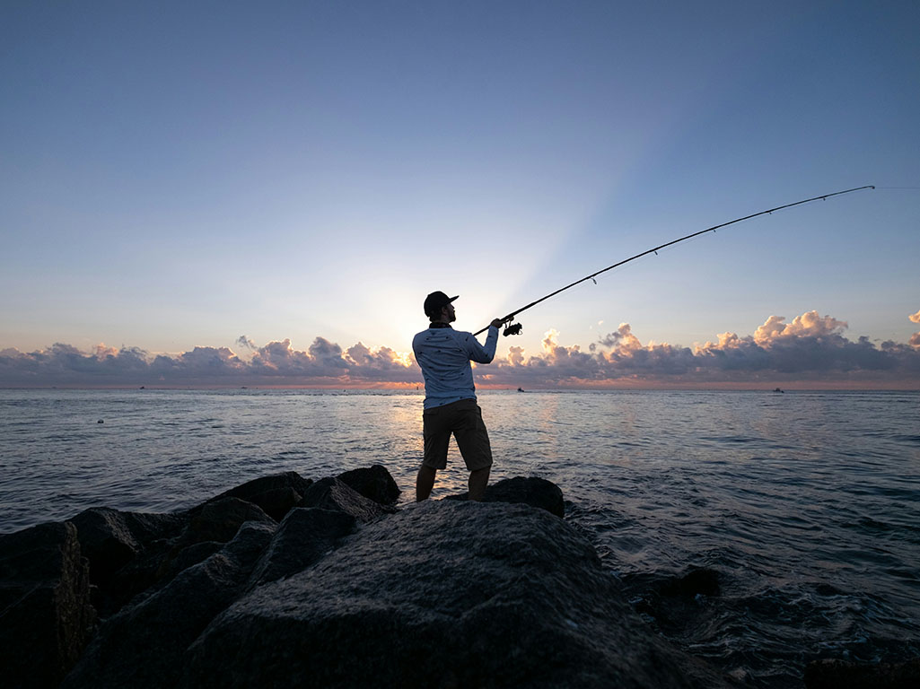 Man casting fishing reel