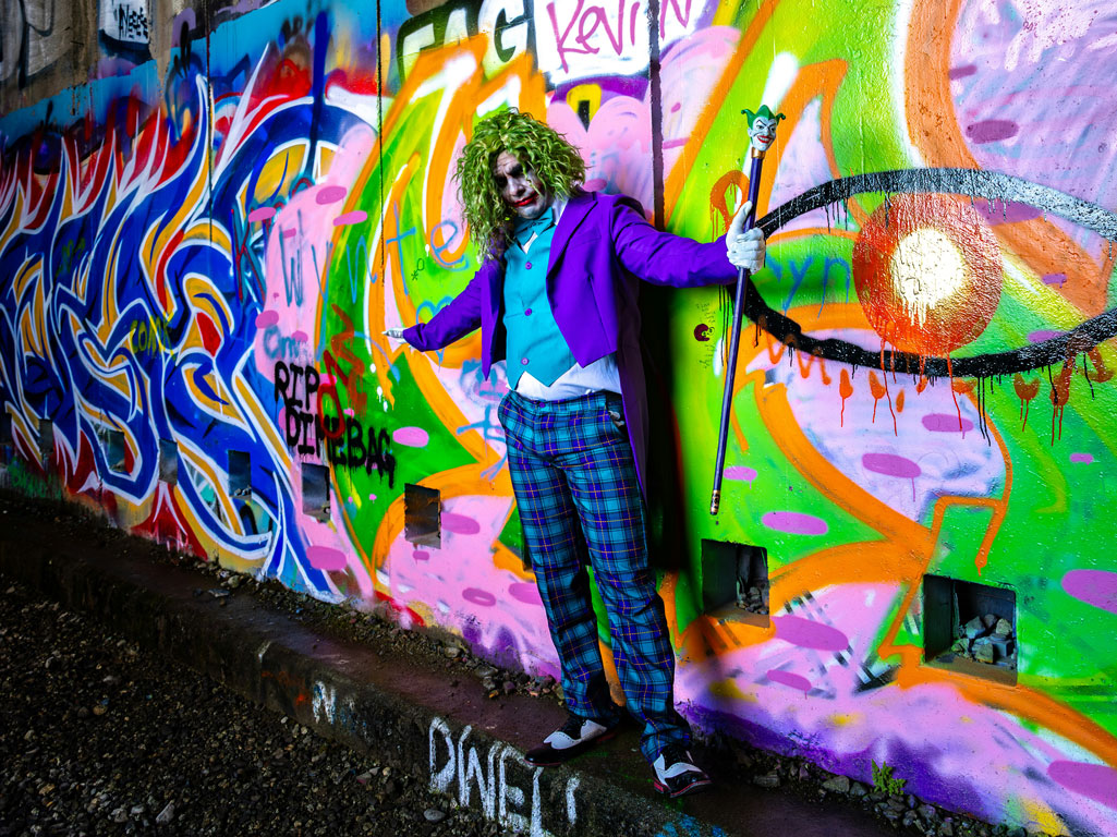 Clown in front of graffiti wall